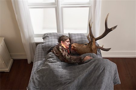 person with deer - Hunter Sleeping with Deer Head Stock Photo - Premium Royalty-Free, Code: 600-01124361