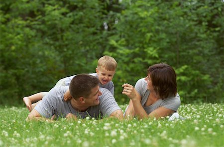 father son lying grass - Family Playing Outdoors Stock Photo - Premium Royalty-Free, Code: 600-01124405