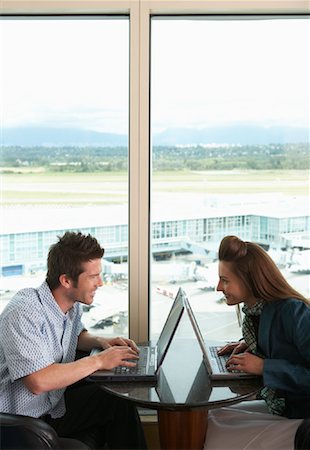 Couple Using Laptops in Airport, Vancouver, British Columbia, Canada Fotografie stock - Premium Royalty-Free, Codice: 600-01124847