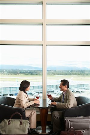 simsearch:600-07117229,k - Couple Toasting in Airport, Vancouver, British Columbia, Canada Stock Photo - Premium Royalty-Free, Code: 600-01124851