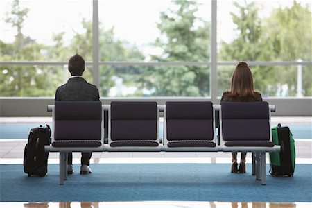 Man and Woman in Airport Waiting Area Stock Photo - Premium Royalty-Free, Code: 600-01124910