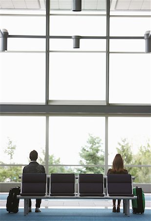 Man and Woman in Airport Waiting Area Fotografie stock - Premium Royalty-Free, Codice: 600-01124911