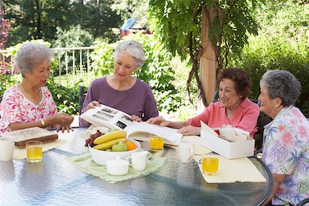 Women Looking at Photographs and Box of Letters Stock Photo - Premium Royalty-Free, Code: 600-01120260