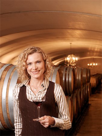 Woman Standing in Wine Cellar Stock Photo - Premium Royalty-Free, Code: 600-01120386