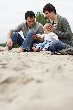 Family with Baby Sitting on Beach Stock Photo - Premium Royalty-Free, Code: 600-01123699