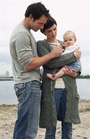 serious mother holding baby - Family with Baby on Beach Stock Photo - Premium Royalty-Free, Code: 600-01123690