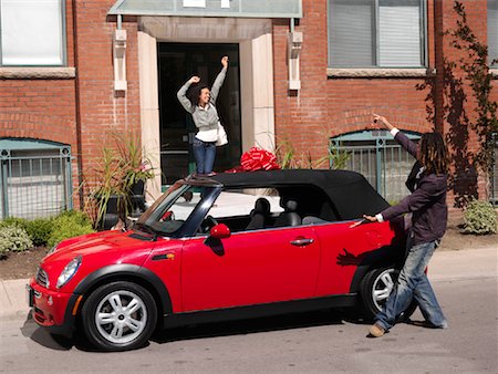 excited african american in a car - Man Giving Woman New Car Stock Photo - Premium Royalty-Free, Code: 600-01164721