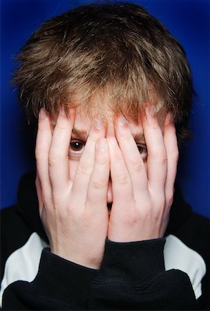 Teenage Boy Covering His Face Stock Photo - Premium Royalty-Free, Code: 600-01163226
