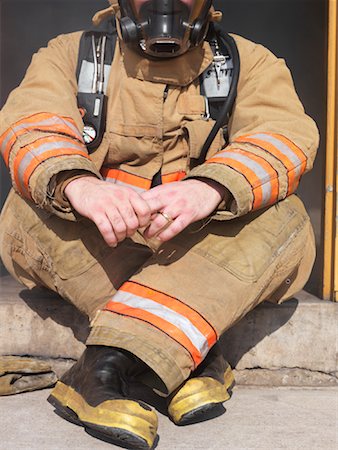 simsearch:400-03938467,k - Firefighter Sitting in Doorway Stock Photo - Premium Royalty-Free, Code: 600-01172222