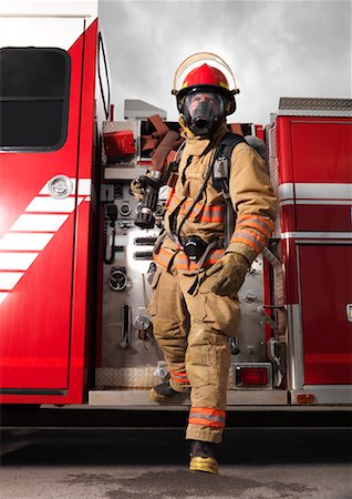 firemen uniform - Fireman Pulling Fire Hose from Fire Truck Stock Photo - Premium Royalty-Free, Code: 600-01172246