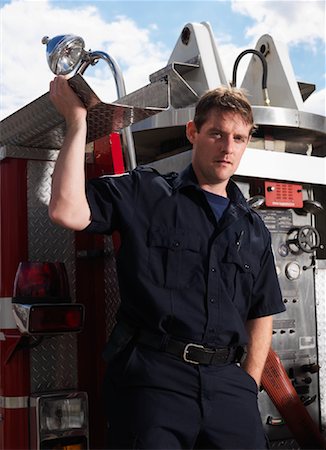 simsearch:600-01172282,k - Firefighter on Back of Fire Truck Stock Photo - Premium Royalty-Free, Code: 600-01172279