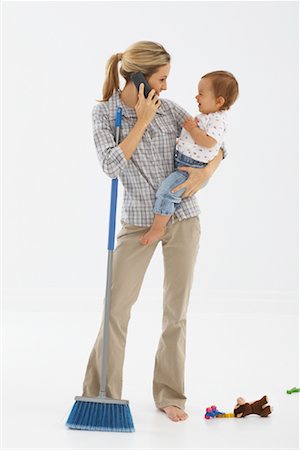 person holding broom - Mother Multitasking Stock Photo - Premium Royalty-Free, Code: 600-01172792