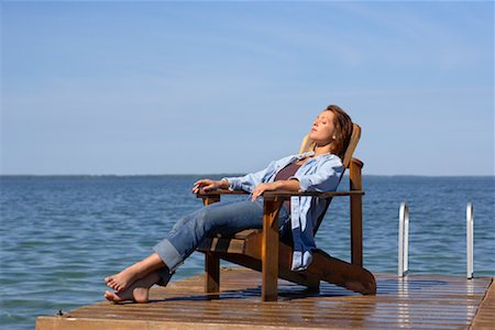 simsearch:600-02010384,k - Woman Relaxing on Dock by Water Stock Photo - Premium Royalty-Free, Code: 600-01172979