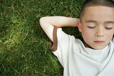 Boy Lying Down on Grass Stock Photo - Premium Royalty-Free, Code: 600-01173613