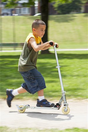 Boy Riding Scooter Stock Photo - Premium Royalty-Free, Code: 600-01173625