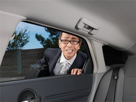 simsearch:600-01173901,k - Businessman Looking in Car Stock Photo - Premium Royalty-Free, Code: 600-01173859