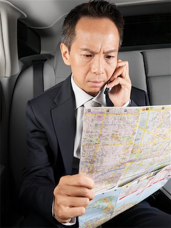 Businessman Looking at Map in Car Stock Photo - Premium Royalty-Free, Code: 600-01173869