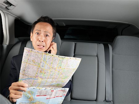 simsearch:600-01173901,k - Businessman Looking at Map in Car Stock Photo - Premium Royalty-Free, Code: 600-01173870