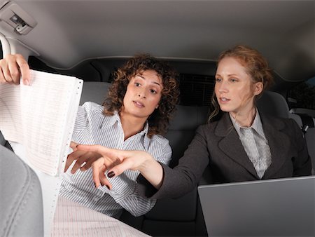 printer paper - Businesswomen Working in Back of Car Stock Photo - Premium Royalty-Free, Code: 600-01173946