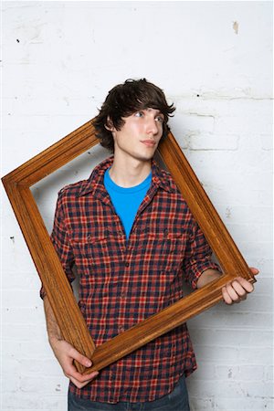 simsearch:600-01695485,k - Young Man Holding Frame Stock Photo - Premium Royalty-Free, Code: 600-01184596