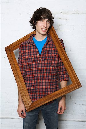 simsearch:600-01695485,k - Young Man Holding Frame Stock Photo - Premium Royalty-Free, Code: 600-01184597