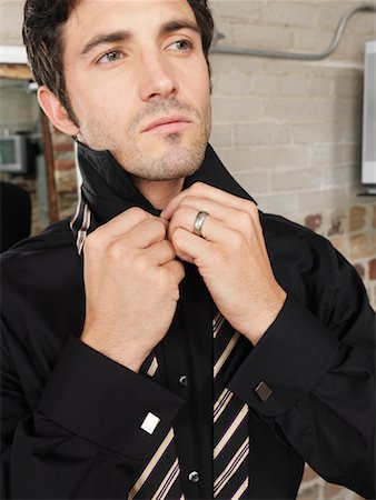 Man Buttoning Shirt Stock Photo - Premium Royalty-Free, Code: 600-01184956