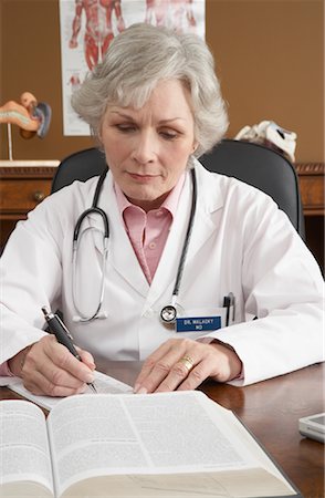 stethoscope on books - Doctor Working at Desk Stock Photo - Premium Royalty-Free, Code: 600-01194776