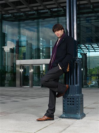 Man Leaning Against Lamppost Stock Photo - Premium Royalty-Free, Code: 600-01194843