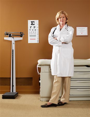 senior woman portrait looking at camera alone full body stand - Doctor in Examination Room Stock Photo - Premium Royalty-Free, Code: 600-01195072