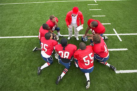 Coach Talking to Football Players in Huddle Stock Photo - Premium Royalty-Free, Code: 600-01196484