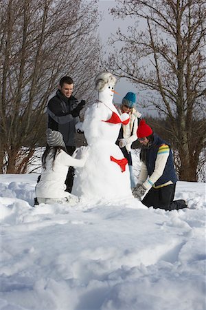 pictures of people in snow in bathing suit - Couples Building a Snow-Woman, Meadow Park, Whistler, British Columbia, Canada Stock Photo - Premium Royalty-Free, Code: 600-01196853