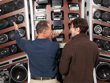 stereo - Man Listening to Salesperson in Electronics Store Stock Photo - Premium Royalty-Free, Code: 600-01198760