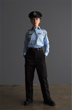 police woman standing - Portrait of Police Officer Stock Photo - Premium Royalty-Free, Code: 600-01199092