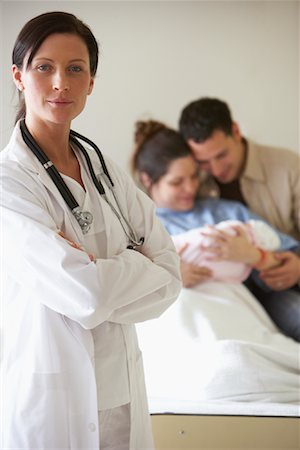 dad holding newborn baby - Portrait of Doctor with Patient in Background Stock Photo - Premium Royalty-Free, Code: 600-01199688