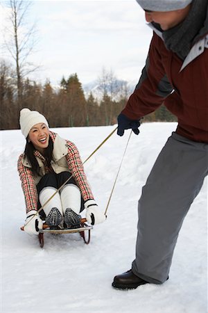 Man Pulling Woman on Sled, Whistler, British Columbia, Canada Stock Photo - Premium Royalty-Free, Code: 600-01224151