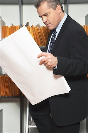 Businessman Looking at Records Stock Photo - Premium Royalty-Free, Code: 600-01235074