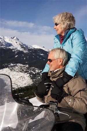 snowmobile man and woman - Couple Snowmobiling Stock Photo - Premium Royalty-Free, Code: 600-01235187