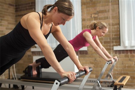 pilates reformer - Women on Pilates Exercise Machines Stock Photo - Premium Royalty-Free, Code: 600-01235867