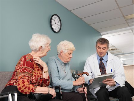 simsearch:700-07529230,k - Doctor Speaking With Patients Stock Photo - Premium Royalty-Free, Code: 600-01236154