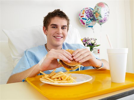 plate of hamburger and fries - Boy Eating Burger in Hospital Room Stock Photo - Premium Royalty-Free, Code: 600-01248205