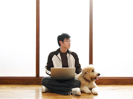 Man Sitting on Floor Using Laptop Stock Photo - Premium Royalty-Free, Code: 600-01248267