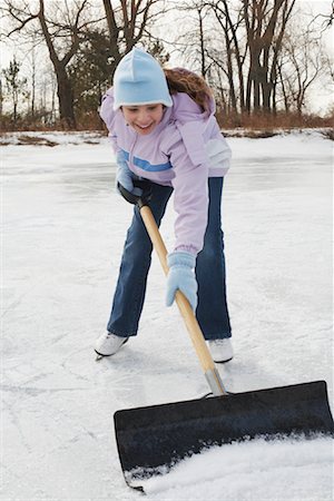 simsearch:600-03814935,k - Girl Shoveling Snow from Rink Stock Photo - Premium Royalty-Free, Code: 600-01249391