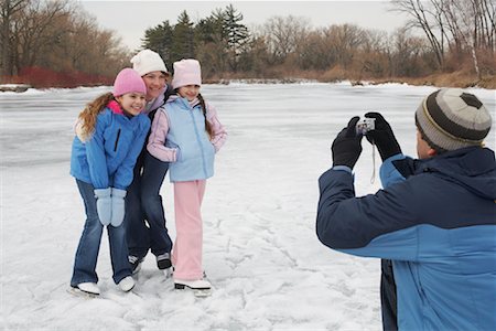 simsearch:600-01224175,k - Father Taking Picture of Family Skating Stock Photo - Premium Royalty-Free, Code: 600-01249402