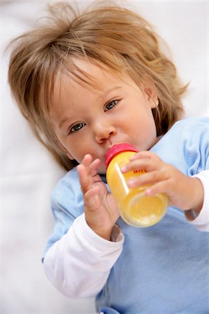Little Girl Drinking From Bottle Stock Photo - Premium Royalty-Free, Code: 600-01260129