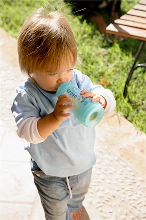 Little Girl Drinking From Bottle Stock Photo - Premium Royalty-Free, Code: 600-01260131