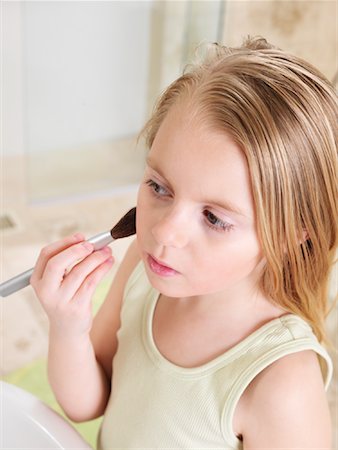 pictures of girls brushing blonde hair - Girl Applying Blush Stock Photo - Premium Royalty-Free, Code: 600-01260392