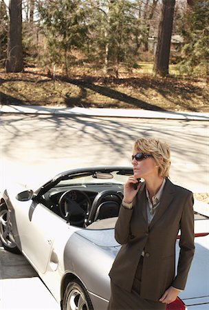 simsearch:600-01464361,k - Businesswoman with Cellular Phone Leaning against Car Stock Photo - Premium Royalty-Free, Code: 600-01275495