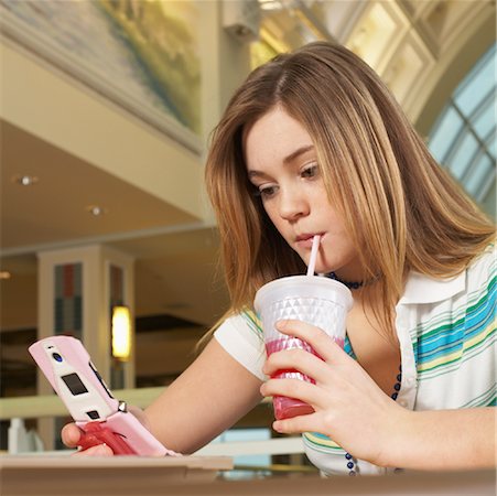 Teenager Looking at Cell Phone Stock Photo - Premium Royalty-Free, Code: 600-01275521