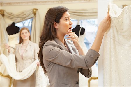 simsearch:600-03686255,k - Woman in Bridal Boutique Looking at Price Tag Stock Photo - Premium Royalty-Free, Code: 600-01276319