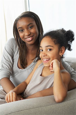 Portrait of Sisters on Sofa Stock Photo - Premium Royalty-Free, Code: 600-01276346